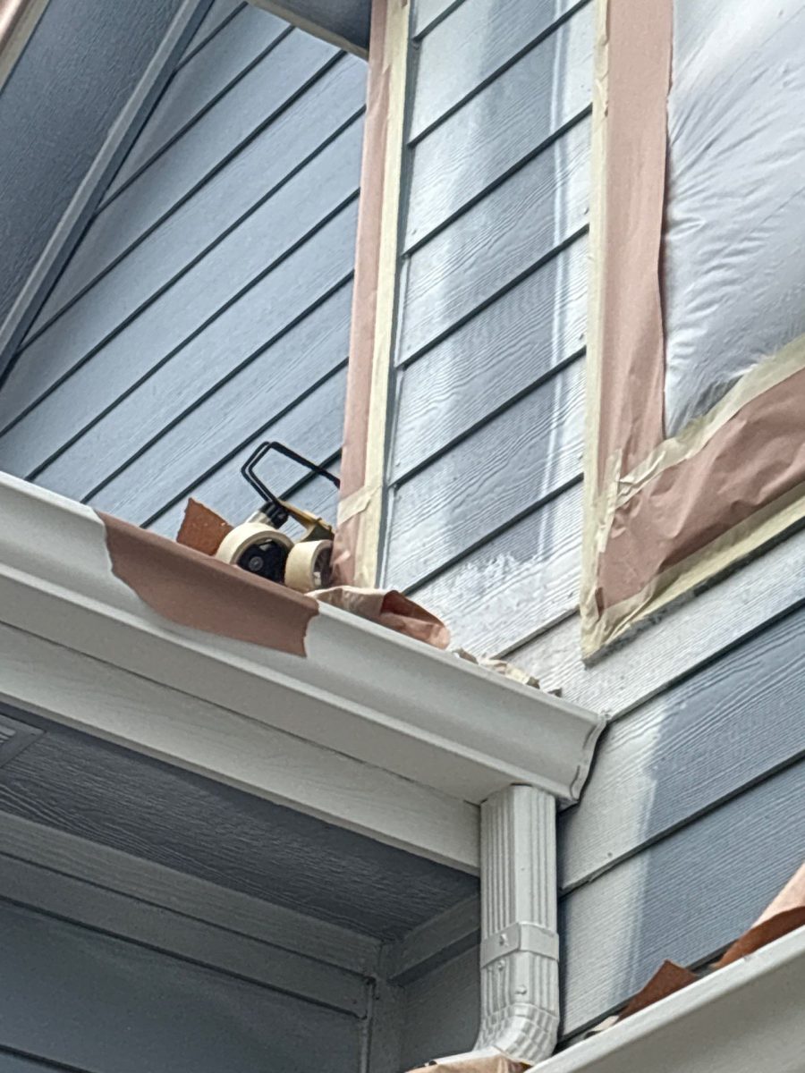 side of house with blue siding and trim covered in protective layer Preview Image 9