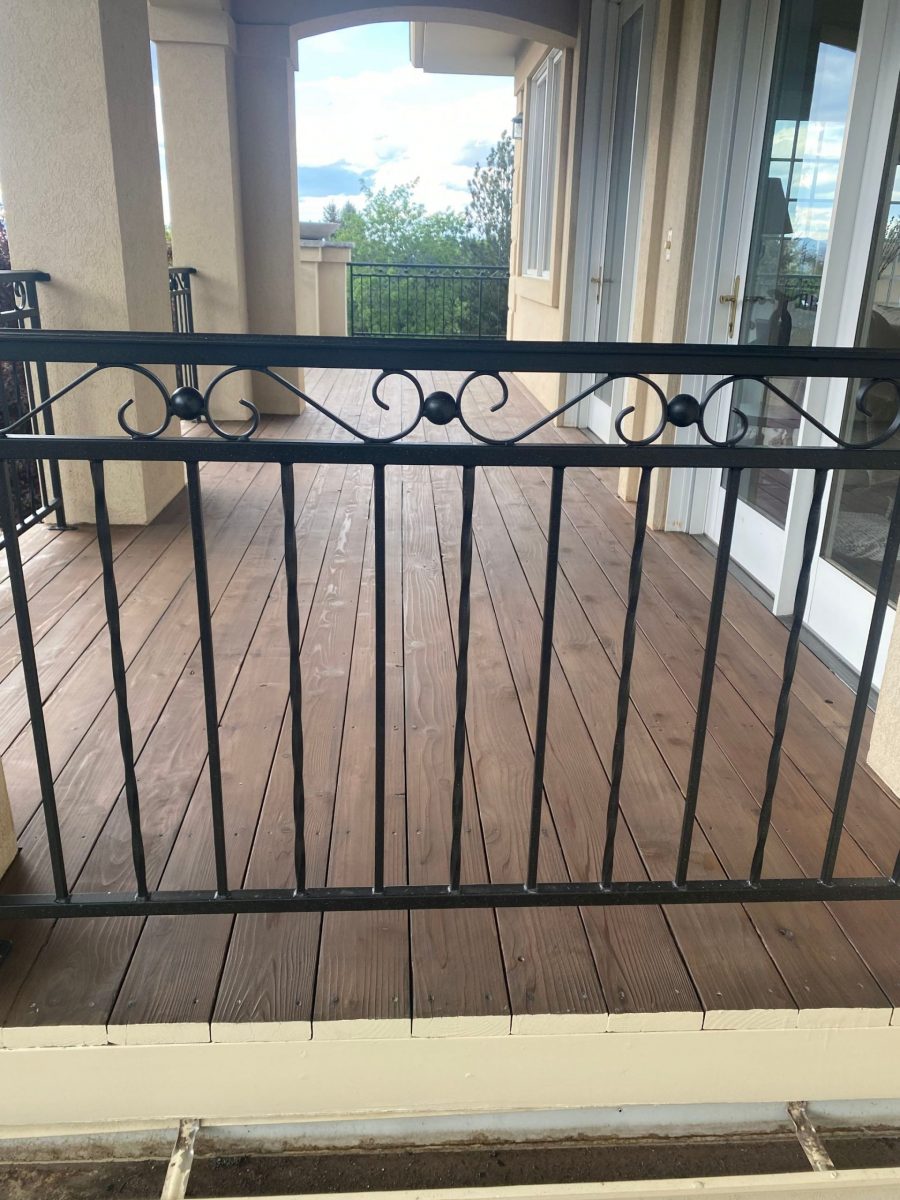 stained wooden deck with black metal railing Preview Image 1