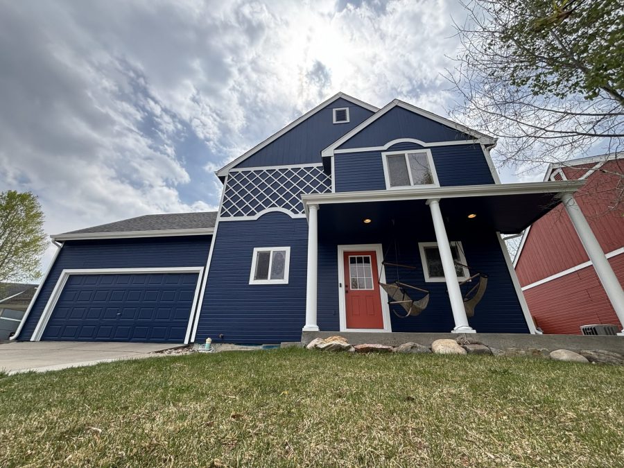 blue painted house with white trim and red door Preview Image 2