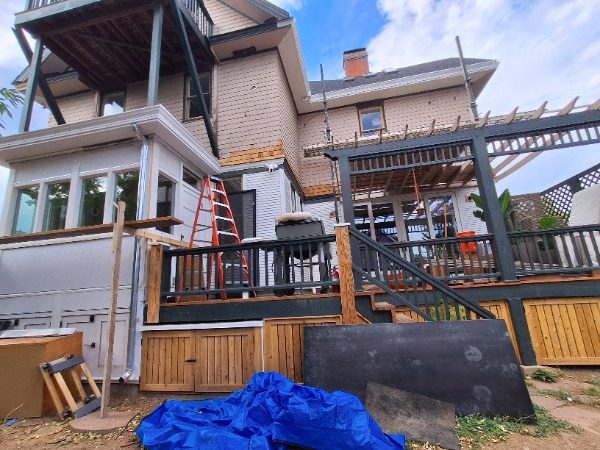 front view of house with wrap porch during painting Preview Image 9