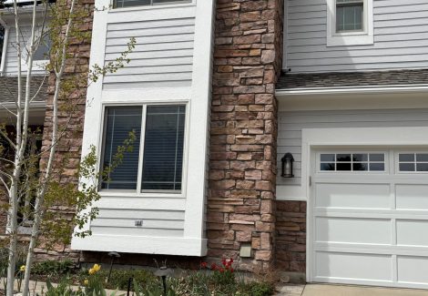 front exterior of house with stone and painted siding