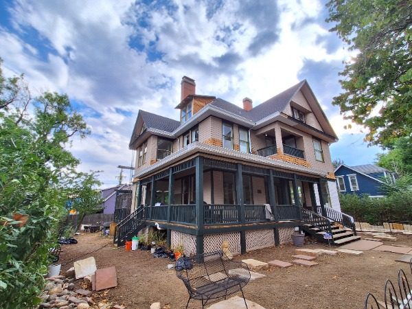 front view of house with wrap porch during painting Preview Image 8