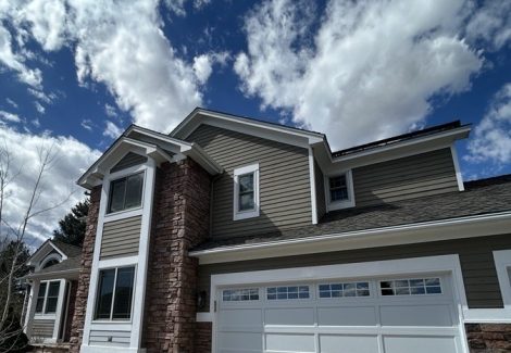 front exterior of house with stone and painted siding | garage view