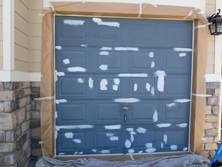 blue garage door with primer during repaint Preview Image 12