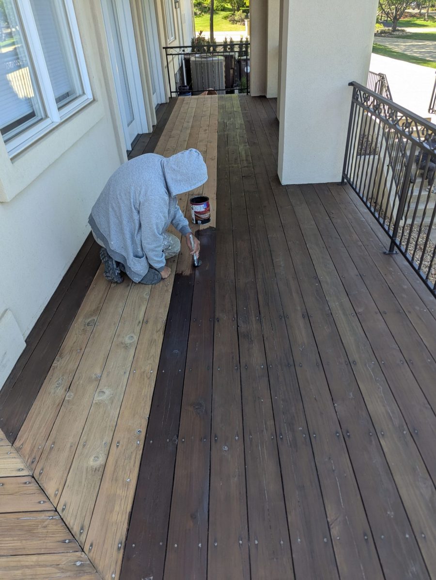 painter stripping old stain from wooden deck Preview Image 14