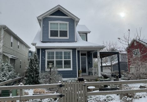 snow covered house with blue-grey trim