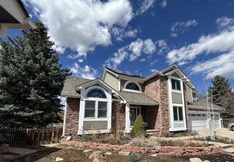 front exterior of house with stone and painted siding