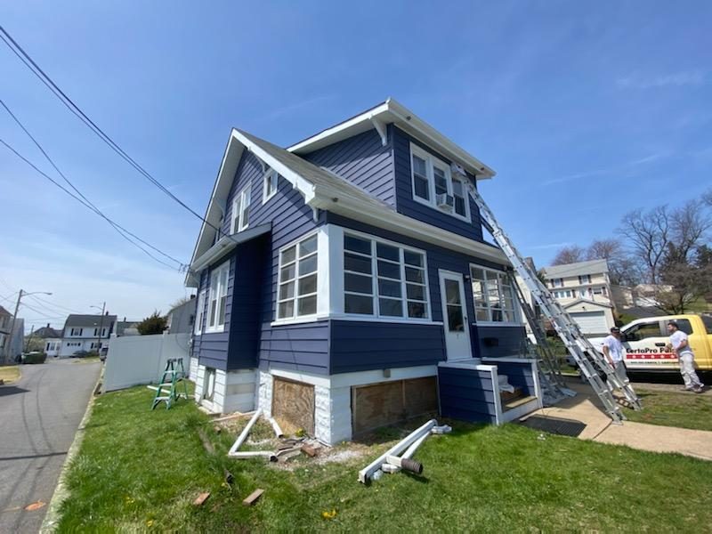 progress view of dark blue and white trim being painted Preview Image 2