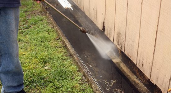 Commercial Power Washing Services man washing curb