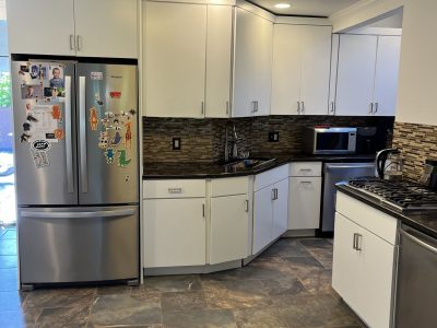 white kitchen cabinets with black counter tops