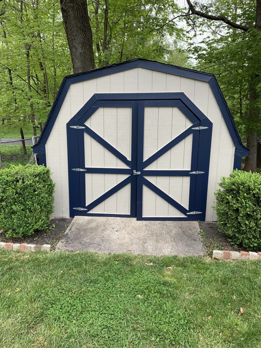 white shed with black handles and accents