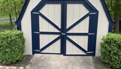 white shed with black handles and accents