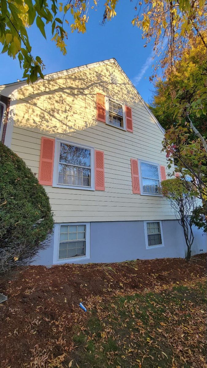 Side view of yellow exterior after completed residential exterior painting project in Melrose, MA, by CertaPro Painters of North Shore & Cape Ann, MA - Angle 2 Preview Image 2