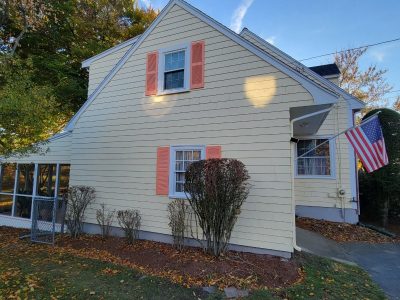 Side view of yellow exterior after completed residential exterior painting project in Melrose, MA, by CertaPro Painters of North Shore & Cape Ann, MA