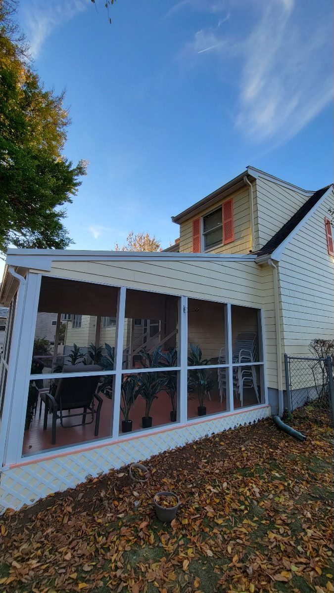 Side View of Back Porch after completed residential exterior painting project in Melrose, MA by CertaPro Painters of North Shore & Cape Ann, MA Preview Image 1