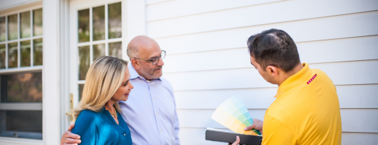 CertaPro Painters team member and homeowners going over exterior color choices
