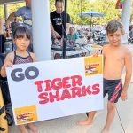 kids holding sign