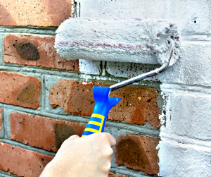 painting a brick home with white paint in castle rock