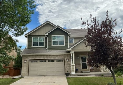 driveway view of home with two tone color siding