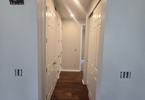 white hallway with wooden floors