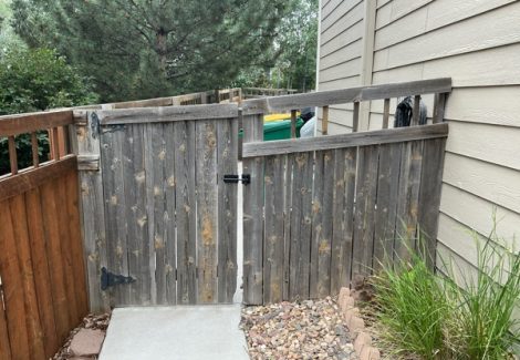 worn wooden fence attached to home