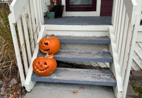 wooden porch steps with worn paint and jackolanterns