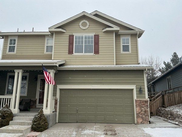 driveway and garage door on front of painted house with two tones of siding Preview Image 4