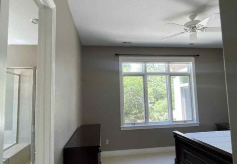bedroom with bed and large windows