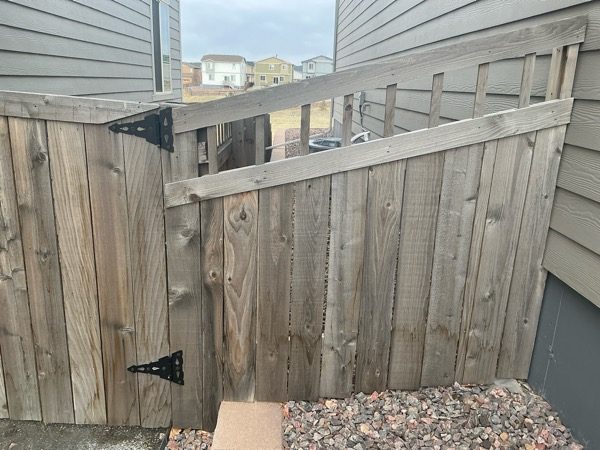 worn wooden fence gate against house Preview Image 4