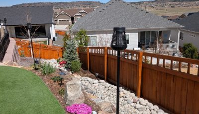 stained wooden fence dividing multiple houses
