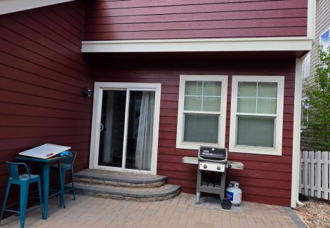 house exterior with dark red painted siding and white trim