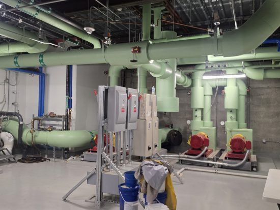 boiler room with orange, blue and green painted pipes