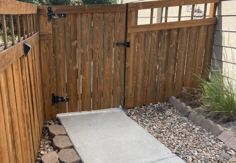 stained fence attached to side of house