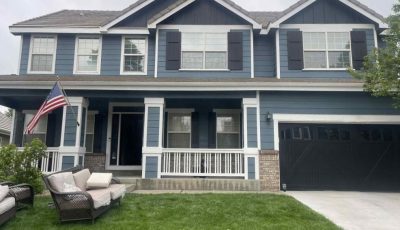 front of house with blue painted siding and white trim