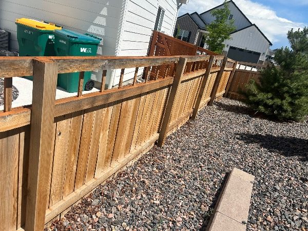 gravel landsaping and stained wooden fence surrounding home Preview Image 2