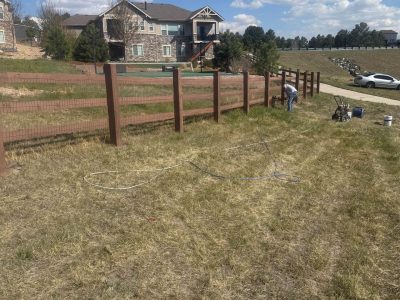 stained split rail fence surrounding residential neighborhood