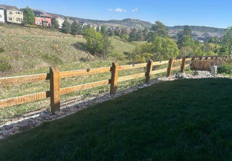 unstained fence surrounding house and yard