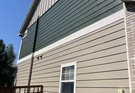 side of house with green and tan siding