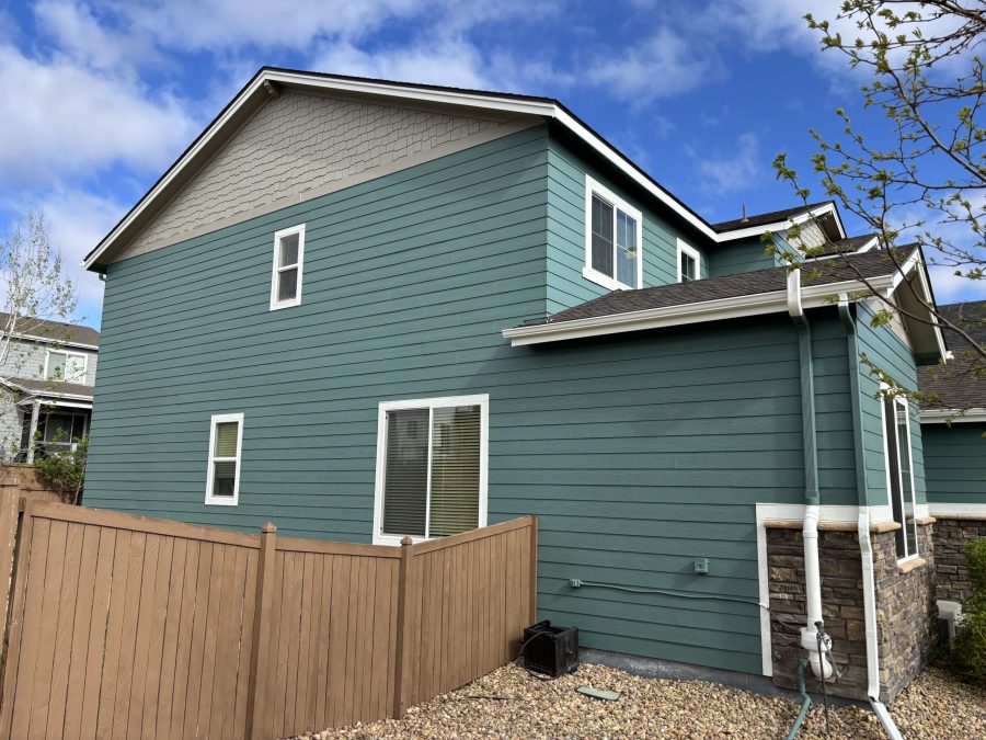 side exterior of house with teal painted siding and grey soffits Preview Image 2