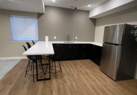 extended counter with stools and refrigerator