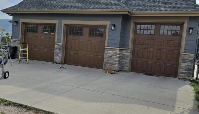 three car garage with brown painted doors