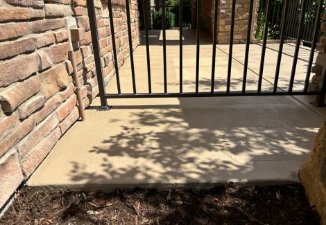 coated concrete patio with metal railing