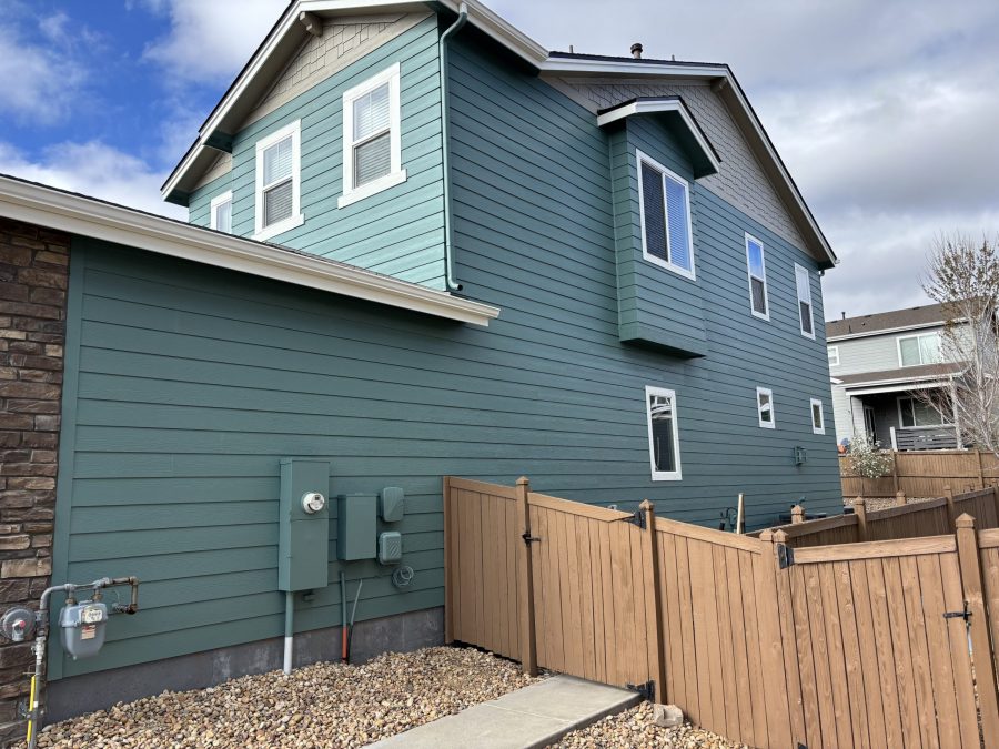 side exterior of house with teal painted siding and grey soffits Preview Image 3