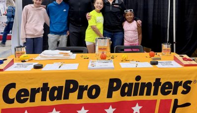 group of adults and children at CertaPro table