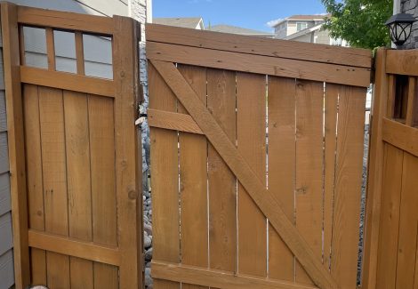 stained fence gate against house