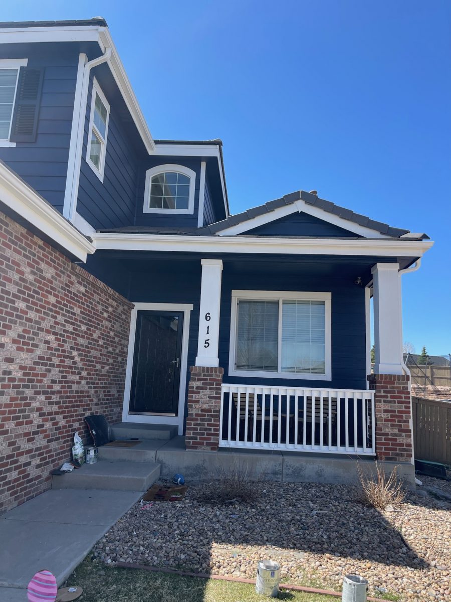 front door and porch of blue painted house Preview Image 1