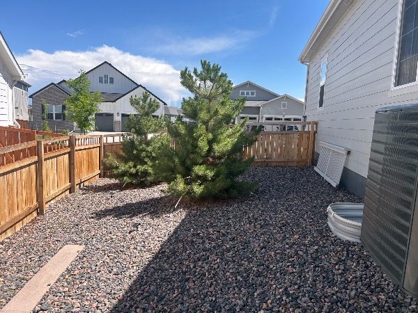 gravel landsaping and stained wooden fence surrounding home Preview Image 1