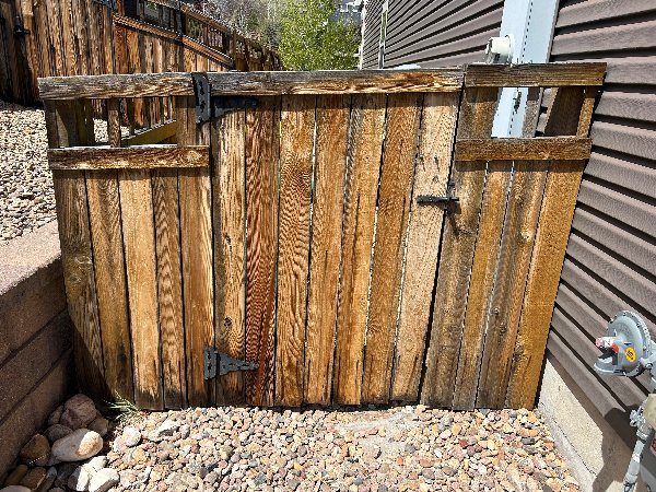 wooden fence outside of a home with worn stain Preview Image 4