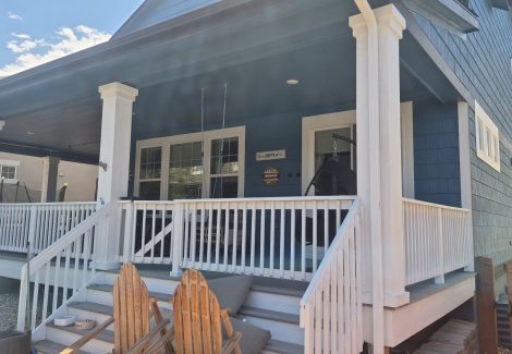 house exterior with blue siding and white porch pillars and railing