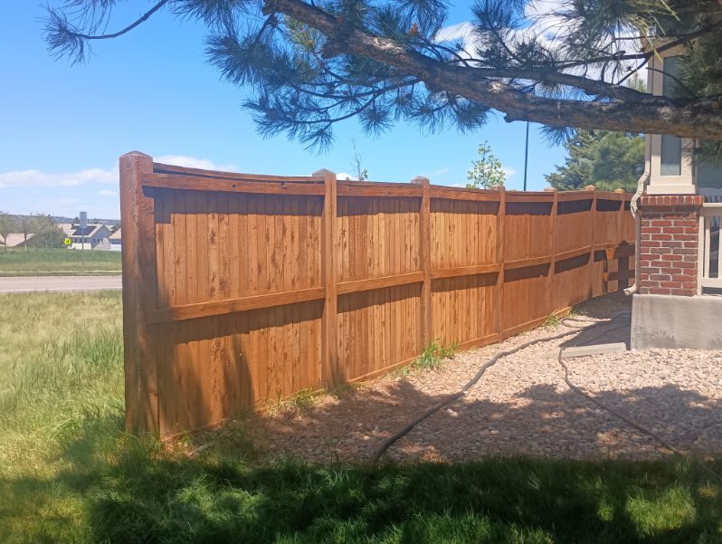 stained wooden fence surrounding yard